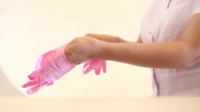 The doctor puts rubber gloves on his hand. the medic is preparing for surgery. Concept of medicine, medical instruments, healthcare. Isolated, copy space