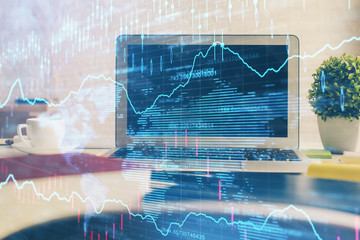 Financial market graph hologram and personal computer on background. Multi exposure. Concept of forex.