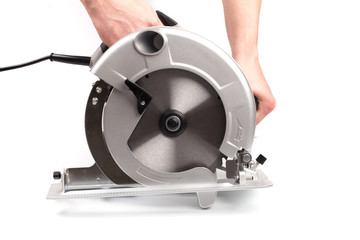 Electric circular saw holding by mans hands .Circular saw is designed for cutting wood and plastic....