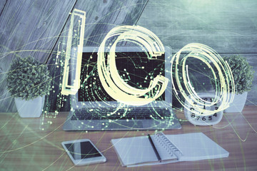 Double exposure of blockchain theme hologram and table with computer background. Concept of bitcoin crypto currency.