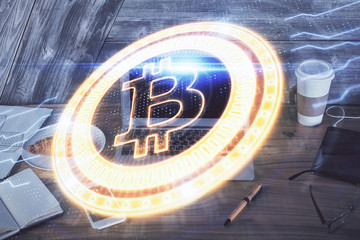 Double exposure of blockchain theme hologram and table with computer background. Concept of bitcoin crypto currency.