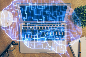Multi exposure of work table with computer and brain hologram. Brainstorm concept.