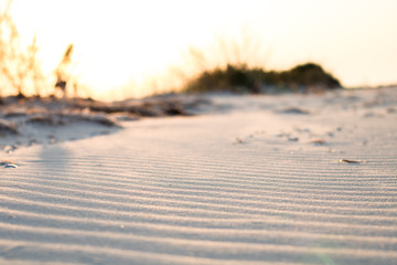 close-up view of the sand with waves on the beach, sunset time
