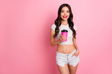 Fototapeta na wymiar Portrait of her she nice attractive lovely charming gorgeous cheerful cheery wavy-haired girl drinking hot sweet latte isolated over pink pastel color background