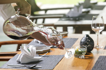 Wine decanter, wineglasses and red wine. Decanting wine ensures that the sediment stays in the...