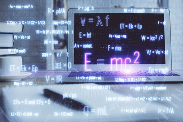 Desktop computer background and formula hologram writing. Double exposure. Education concept.