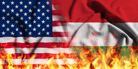 National flag of the United States with Hungary on a waving cotton with a fire texture 