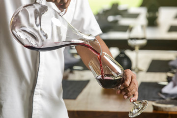 Wine decanter, wineglasses and red wine. Decanting wine ensures that the sediment stays in the...