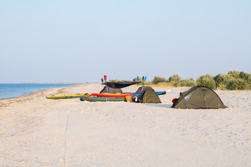 Fototapeta na wymiar expedition camp with tents and kayaks on the beach