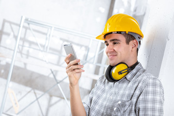 Builder, architect or engineer using a mobile