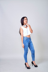 Asian woman wearing headphones dancing active