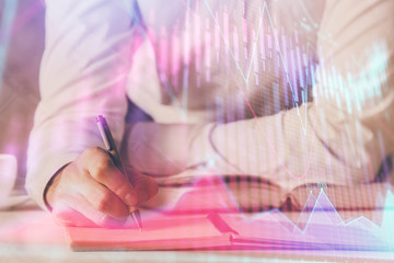 Financial trading chart double exposure with man desktop background.