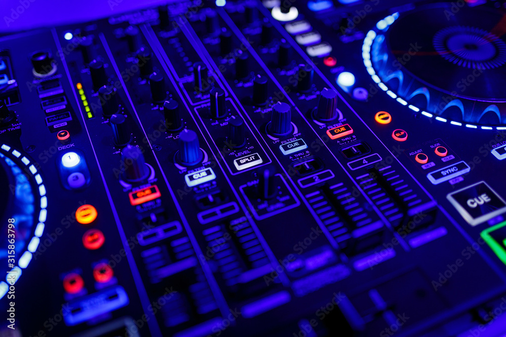 Wall mural closeup view of a dj's mixing desk