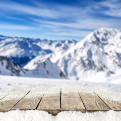 desk of free space cover of snow and winter landscape of mountains. 
