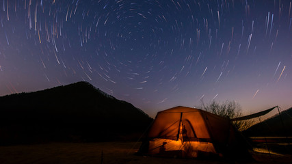 Fototapeta na wymiar South Korea's rural riverside night tents and star trails.