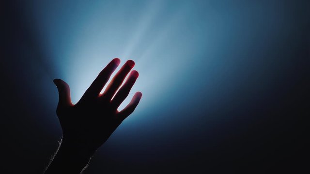 The helping hand stretches from top to the man's hand