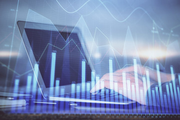 Double exposure of stock market graph with man working on laptop on background. Concept of financial analysis.