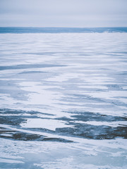 Ice landscape, endless panorama of the ice surface on the frozen river