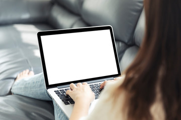 Young woman doing research work for her business, Smiling woman on sofa relaxing while browsing online shopping website, Women using laptop with blank screen at sofa.