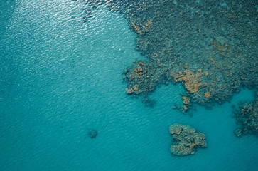 Aerial top view of the blue ocean and coral reef on sunny day. Sea surface. Ecology concept, sea nature