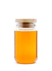 Honey jar with wooden cap on white background