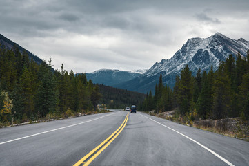 Road trip with Rocky mountains in autumn forest on gloomy at Banff national park
