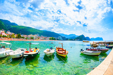 Naklejka na ściany i meble Port with boats and beautiful beach in Petrovac, Montenegro. Summer landscape, sea view. Famous travel destination