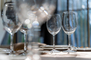 Beautiful table setting with glasses, plates and napkins. Clouse-up.