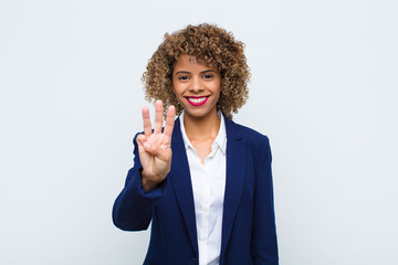young woman african american smiling and looking friendly, showing number three or third with hand...