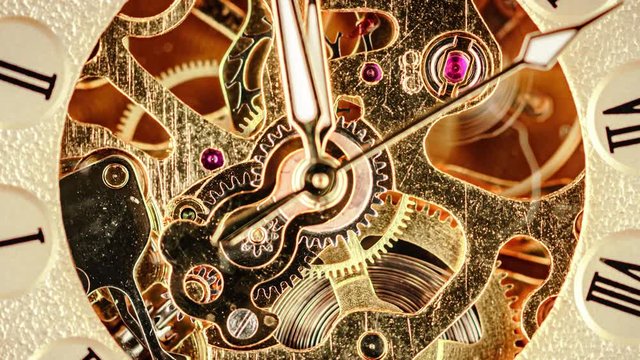 Spiral clock track of time at low depth of field. Focus on the gears.