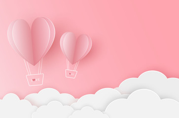Two paper heart balloon flying on the pink sky