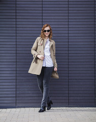 full-length portrait of a beautiful woman in a coat and jeans