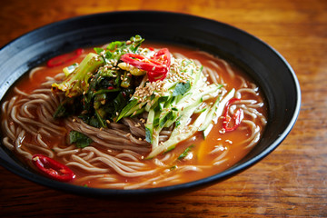 Korean soba noodle with leaf vegetable with spicy soup 