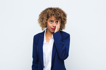 young woman african american feeling bored, frustrated and sleepy after a tiresome, dull and...
