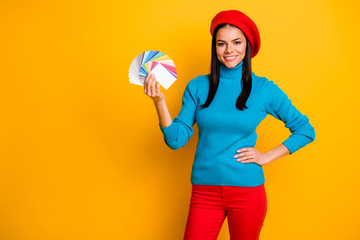 Fototapeta na wymiar Portrait of her she nice attractive lovely confident cheerful cheery girl designer holding in hand palette different color type styling isolated on bright vivid shine vibrant yellow color background