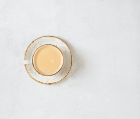Indian Masala chai tea. Traditional Indian hot drink with milk and spices on white concrete...