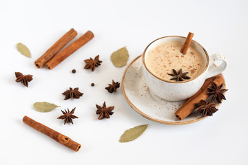 Indian Masala chai tea. Traditional Indian hot drink with milk and spices on white background closeup.