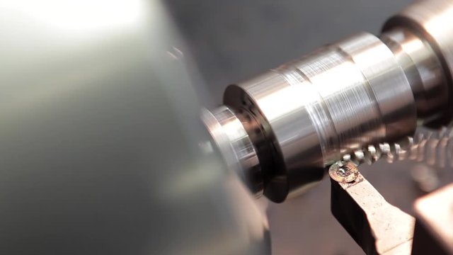 close up of steel turning machine - carwing steel axel