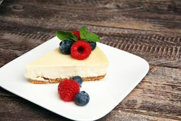 Homemade cheesecake with fresh raspberries and mint for valentines day - healthy organic summer dessert pie cheesecake. Vanilla Cheese Cake for dessert