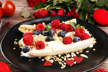 Sweet Homemade Banana Split with yogurt, granola, berries and mint. Banana Split with healthy ingredients