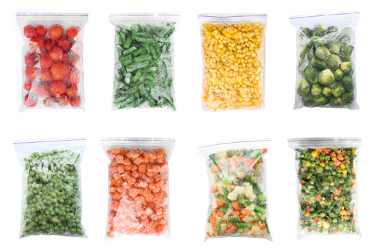 Set of different frozen vegetables in plastic bags on white background, top view
