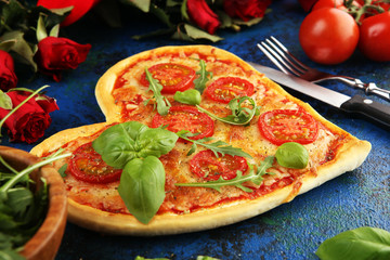 pizza Heart shaped margherita with tomatoes and mozzarella vegetarian. Food concept of romantic love pizza for Valentines Day.