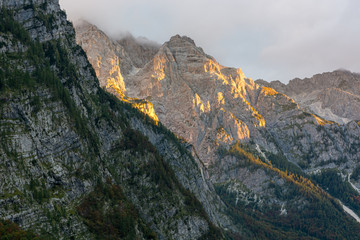 Morning sun illuminating a lush mountain valley.