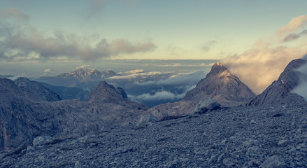 Spectacular mountain view with evening clouds rolling over peaks and ridges.