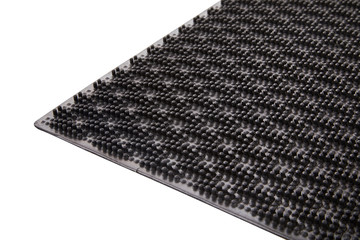 Black rubber entrance mat isolated on white background. Cellular rubber mat for dirt removal....