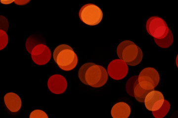 Red and orange bokeh circles on a black background
