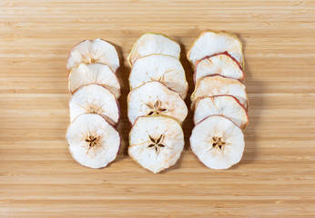Dried apple chips on a cutting Board. Natural organic food.