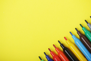 Multicolored markers at bright background