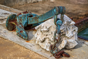 A huge old rusty anchor like a harbor decoration