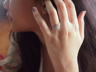 Close-up diamond ring elegant on the beauty woman finger.Love and wedding concept.
